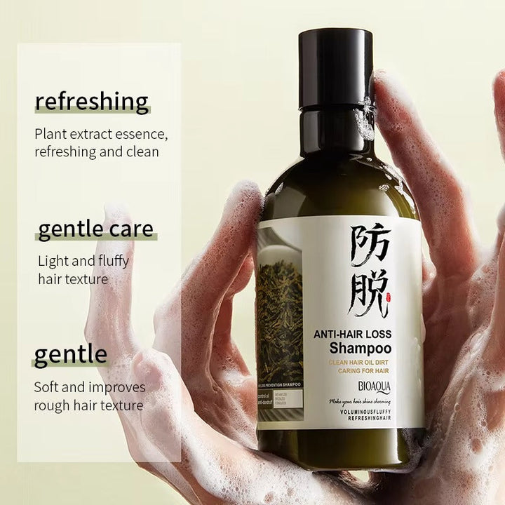 Bottle of Bioaqua Anti-Hair Loss Shampoo held by hands with a beige background